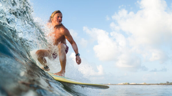 Young surfer rides ocean wave
