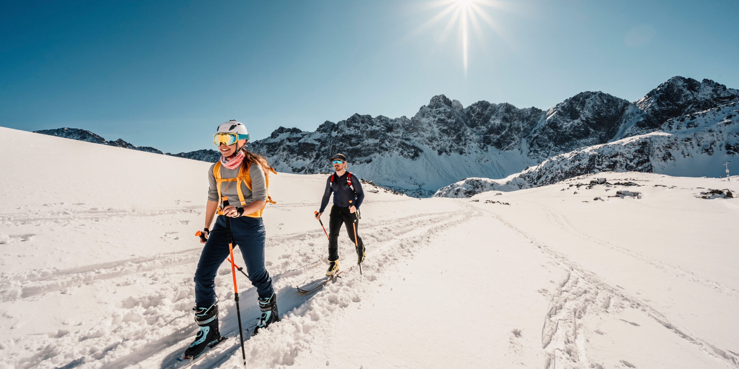 Mountaineer backcountry ski walking ski alpinist in the mountains. Ski touring in alpine landscape with snowy trees. Adventure winter sport. High tatras, slovakia landscape
