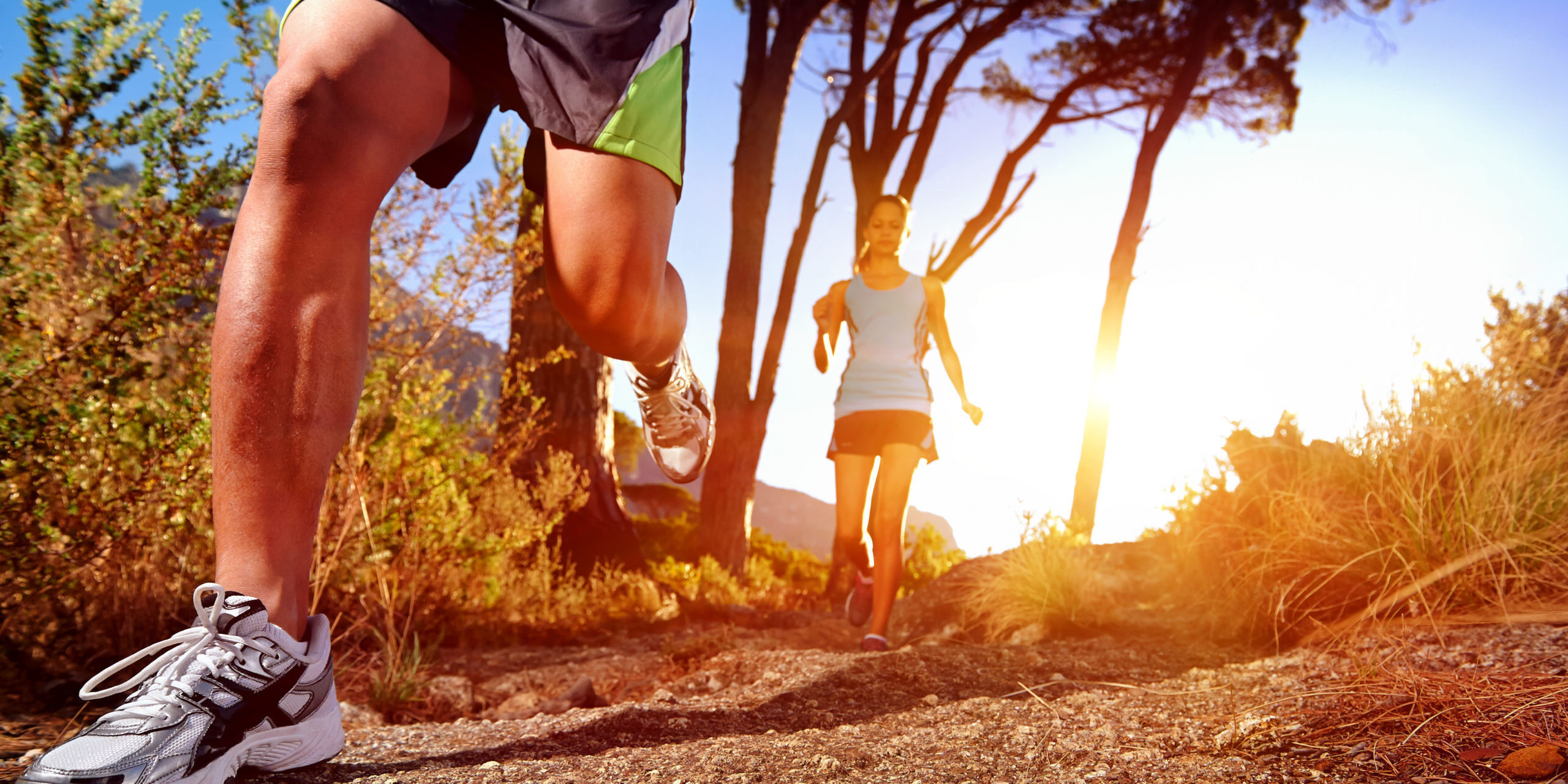 Trail running marathon athlete outdoors sunrise couple training for fitness and healthy lifestyle
